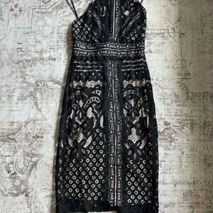 Worn once, tan underlay with black knitting over top. High neck, semi low back.